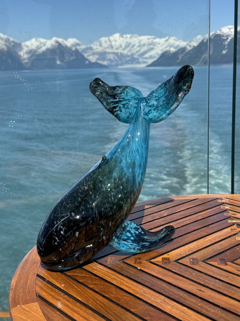 Handblown glass whale sculpture inspired by the Alaskan coastline created during a live glassblowing demonstration by Ethan Ball